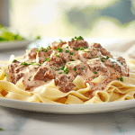 A creamy bowl of homemade Hamburger Helper beef stroganoff topped with fresh parsley